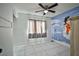 The bedroom features durable tile flooring, a ceiling fan, natural lighting, and a fun mural at 4438 Faberge Ave, Las Vegas, NV 89115