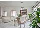 Bright dining area featuring a dining table set with seating, white tile floors and sliding glass door to the yard at 4438 Faberge Ave, Las Vegas, NV 89115