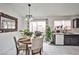 Dining area featuring a dining table set with seating, access to the backyard, and dark wood cabinets at 4438 Faberge Ave, Las Vegas, NV 89115
