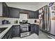 Kitchen featuring dark wood cabinets, white countertops, and stainless steel appliances at 4438 Faberge Ave, Las Vegas, NV 89115