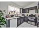Galley kitchen featuring dark wood cabinets, white countertops, and stainless steel appliances at 4438 Faberge Ave, Las Vegas, NV 89115