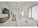 Spacious living room boasts tile floors, comfortable sofa, a modern entertainment center, and access to other rooms at 4438 Faberge Ave, Las Vegas, NV 89115