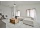 Bright living room features a comfortable, stylish white sectional sofa and white tile floors at 4438 Faberge Ave, Las Vegas, NV 89115