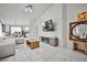 Open concept living room featuring tile floors, stylish sofa, a modern entertainment center, and dining area at 4438 Faberge Ave, Las Vegas, NV 89115