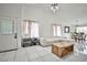 Bright living room features tile floors, stylish sofa, and a view of the dining area at 4438 Faberge Ave, Las Vegas, NV 89115