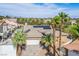 Aerial view of a home with a pool and solar panels, nestled among mature trees in a vibrant neighborhood at 4574 Sheri Lyn Ct, Las Vegas, NV 89121