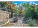 Cozy backyard featuring a paved patio, metal firepit, and lush greenery offering a private outdoor space at 4574 Sheri Lyn Ct, Las Vegas, NV 89121