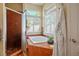 Bright bathroom featuring a soaking tub with jets, and a glass-enclosed shower with tile surround at 4574 Sheri Lyn Ct, Las Vegas, NV 89121