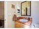 Bathroom vanity area with brown tile, modern sink, and large mirror with access to the toilet at 4574 Sheri Lyn Ct, Las Vegas, NV 89121