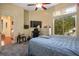 Bedroom with natural lighting featuring a bed, large tv screen, and comfortable desk area at 4574 Sheri Lyn Ct, Las Vegas, NV 89121