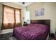 Bedroom featuring cozy carpeting, with a queen bed, nightstand, and large window with natural light at 4574 Sheri Lyn Ct, Las Vegas, NV 89121