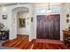 Elegant foyer featuring wood floors, a double door entrance, and an open archway at 4574 Sheri Lyn Ct, Las Vegas, NV 89121