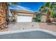 Charming home featuring a well-manicured front yard and a two-car garage, enhanced by beautiful palm trees at 4574 Sheri Lyn Ct, Las Vegas, NV 89121
