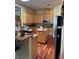 Well-equipped kitchen boasting wooden cabinets, a microwave, and an island, ideal for cooking and storage at 4574 Sheri Lyn Ct, Las Vegas, NV 89121