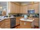 Bright kitchen with granite countertops, wooden cabinets, stainless steel appliances, and a functional island at 4574 Sheri Lyn Ct, Las Vegas, NV 89121
