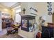 Cozy living room featuring unique fireplace, comfortable seating, and decorative shelving at 4574 Sheri Lyn Ct, Las Vegas, NV 89121