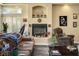 Living room featuring a fireplace and a brown armchair, creating a cozy and inviting space at 4574 Sheri Lyn Ct, Las Vegas, NV 89121
