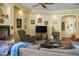 Living room showcasing a fireplace, comfortable seating, and a TV, ideal for relaxation and entertainment at 4574 Sheri Lyn Ct, Las Vegas, NV 89121