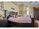 Spacious bedroom with a large bed, ceiling fan, and decorative touches at 4574 Sheri Lyn Ct, Las Vegas, NV 89121