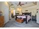 Expansive bedroom with fireplace, ceiling fan, cozy sitting area and neutral carpeting at 4574 Sheri Lyn Ct, Las Vegas, NV 89121