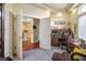 Office leading to the kitchen, featuring a wooden desk, chair, and ample storage at 4574 Sheri Lyn Ct, Las Vegas, NV 89121