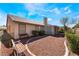 Low-maintenance backyard featuring desert landscaping and covered bench at 5433 Honey Mesquite Ln, Las Vegas, NV 89130