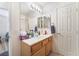 Bathroom with light wood cabinets, ample counter space, and a large mirror at 5433 Honey Mesquite Ln, Las Vegas, NV 89130