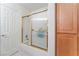 Bright bathroom features a shower-tub combo with gold trim and linen closet for ample storage at 5433 Honey Mesquite Ln, Las Vegas, NV 89130