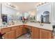 Large bathroom with double sinks, a vanity area, white counters and wood cabinets at 5433 Honey Mesquite Ln, Las Vegas, NV 89130