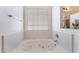 Bathroom features a soaking tub with tile surround and a window with natural light at 5433 Honey Mesquite Ln, Las Vegas, NV 89130