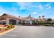 Elegant clubhouse exterior with a porte-cochere, well-maintained landscaping, and ample parking at 5433 Honey Mesquite Ln, Las Vegas, NV 89130