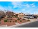 Exterior shot of single-story home with neutral stucco, tile roof, desert landscaping, and an attached garage at 5433 Honey Mesquite Ln, Las Vegas, NV 89130
