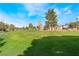 Scenic view of a lush green golf course with mature trees and blue skies on a sunny day at 5433 Honey Mesquite Ln, Las Vegas, NV 89130
