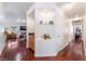 Hallway with hardwood floors, built-in shelves, and a view into a living area with a fireplace at 5433 Honey Mesquite Ln, Las Vegas, NV 89130