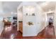 Hallway with hardwood floors, built-in shelves, and a view into a living area with a fireplace at 5433 Honey Mesquite Ln, Las Vegas, NV 89130