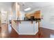 Bright kitchen with breakfast bar, granite countertops, and rich wood floors at 5433 Honey Mesquite Ln, Las Vegas, NV 89130