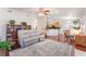 Open-concept living room featuring wood floors, ceiling fan, and view of the kitchen at 5433 Honey Mesquite Ln, Las Vegas, NV 89130