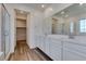 Elegant bathroom with double sinks, a large mirror, and a glass-enclosed shower at 5730 Sky Pointe Dr # 165, Las Vegas, NV 89130