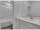 Modern bathroom featuring white cabinets, subway tiled shower/tub, and an expansive mirror at 5730 Sky Pointe Dr # 165, Las Vegas, NV 89130