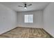 Inviting carpeted bedroom with a ceiling fan and window letting in ample natural light at 5730 Sky Pointe Dr # 165, Las Vegas, NV 89130