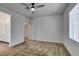 Comfortable carpeted bedroom with ceiling fan and adjoining bathroom access and a window at 5730 Sky Pointe Dr # 165, Las Vegas, NV 89130