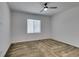 Clean bedroom with neutral carpet, a ceiling fan, and a window providing plenty of light at 5730 Sky Pointe Dr # 165, Las Vegas, NV 89130
