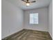 Neutral carpeted bedroom featuring a ceiling fan, window with blinds, and ample natural light at 5730 Sky Pointe Dr # 165, Las Vegas, NV 89130