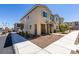 Exterior side view of a modern townhome with low-maintenance landscaping and a bright blue sky at 5730 Sky Pointe Dr # 165, Las Vegas, NV 89130