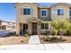 Inviting townhome entrance with stone accents, neutral tones, and xeriscaped front yard at 5730 Sky Pointe Dr # 165, Las Vegas, NV 89130