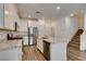 Modern kitchen featuring white cabinets, granite countertops, stainless steel appliances, and an island at 5730 Sky Pointe Dr # 165, Las Vegas, NV 89130