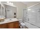 Bathroom featuring a tub-shower combo with glass doors, single sink, and tile floor at 6022 Quintillion Ave, Las Vegas, NV 89122