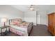 Bedroom with neutral colors, dark wood floors, ceiling fan, and a comfortable atmosphere at 6022 Quintillion Ave, Las Vegas, NV 89122