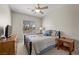 Comfortable bedroom with neutral colors, carpeted floor, ceiling fan, and a large window at 6022 Quintillion Ave, Las Vegas, NV 89122