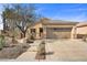 Charming exterior of home with desert landscaping, stone accents, and large driveway at 6022 Quintillion Ave, Las Vegas, NV 89122